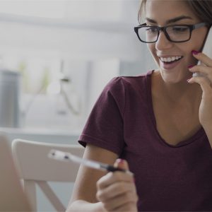 Lady on phone and in front of computer