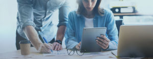 Couple reviewing savings with computers and graphs, super clearing house concept