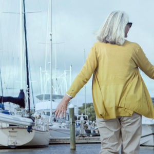 Happy retired couple with boats in background