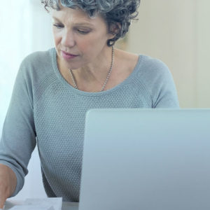 Lady working on her computer - how much super do I need concept