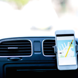 Uber driver using smarphone GPS to follow the route.