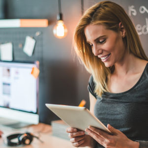 Young businesswoman working on her tablet in the office, demonstrating an innovative approach