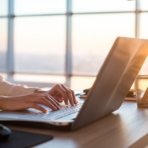 Woman writing a blog on her laptop