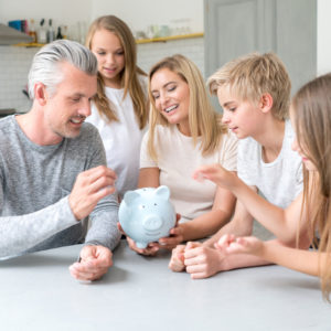 Family saving money in a piggybank