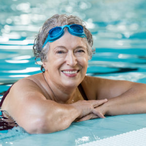 Elderly woman in pool - representing super management for women