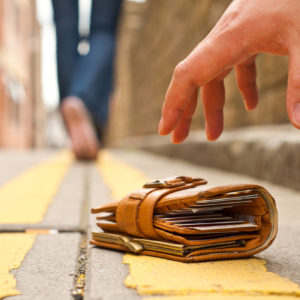 guy picking up a lost a lost wallet, representing lost super funds