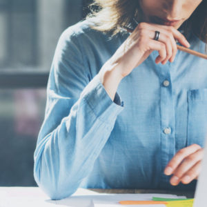 Young woman writing her business plan