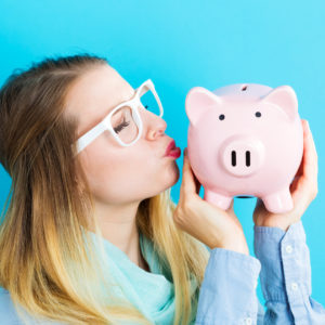 Young woman with a piggy bank, representing savings and superannuation for retirement