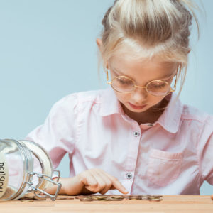 Little girl counting coins. Savings for allocated pension concept.